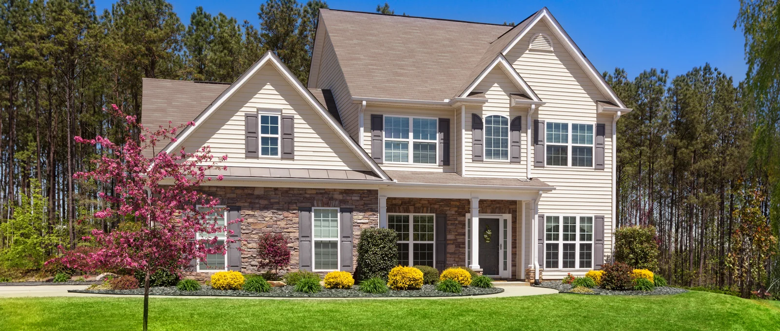 two story home with a nice lawn